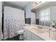 Compact bathroom with a shower-tub, a vanity with sink, and tiled backsplash at 564 Allana Ct, Stone Mountain, GA 30087