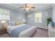 Comfortable bedroom with a queen-size bed, ceiling fan, and cheerful decor at 564 Allana Ct, Stone Mountain, GA 30087