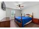 Cozy bedroom with dark furniture, a ceiling fan, plush carpet and bright windows at 564 Allana Ct, Stone Mountain, GA 30087