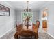 Bright dining room features decorative floors, wooden table set, and access to the backyard at 564 Allana Ct, Stone Mountain, GA 30087