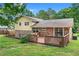 Back exterior of brick home with deck and walkout basement at 564 Allana Ct, Stone Mountain, GA 30087