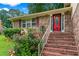 Inviting exterior features lush green lawn, mature trees, and a two-car garage, enhancing the property's appeal at 564 Allana Ct, Stone Mountain, GA 30087