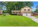 Well-equipped kitchen boasts stainless steel appliances, wood cabinetry, and hardwood floors for a warm, functional space at 564 Allana Ct, Stone Mountain, GA 30087