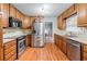 Efficient kitchen featuring stainless steel appliances, wood cabinets, and ample counter space for meal preparation at 564 Allana Ct, Stone Mountain, GA 30087