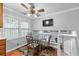 Eat-in kitchen features a ceiling fan, view of backyard, and access to the second floor at 564 Allana Ct, Stone Mountain, GA 30087