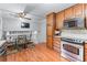 Eat-in kitchen with wood floors, stainless steel appliances, and modern lighting fixture at 564 Allana Ct, Stone Mountain, GA 30087