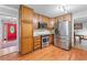Open kitchen with stainless steel appliances, wood cabinets, and view to the red front door at 564 Allana Ct, Stone Mountain, GA 30087