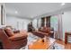 Elegant living room boasts hardwood floors, crown molding, and stylish furnishings for a sophisticated ambiance at 564 Allana Ct, Stone Mountain, GA 30087