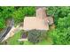 Aerial view of a home with a well-maintained roof, mature trees, and lush lawn at 5770 Dorsett Shoals Rd, Douglasville, GA 30135