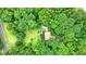 Aerial view showcasing the home nestled among the lush greenery and surrounding trees at 5770 Dorsett Shoals Rd, Douglasville, GA 30135