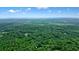 Expansive aerial view showcasing lush, dense forestry surrounding a homesite on a sunny day at 5770 Dorsett Shoals Rd, Douglasville, GA 30135