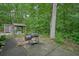 View of the backyard with a grill, covered patio, and storage shed at 5770 Dorsett Shoals Rd, Douglasville, GA 30135