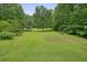 Lush backyard showing mature trees and well-maintained lawn at 5770 Dorsett Shoals Rd, Douglasville, GA 30135