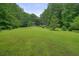 Expansive backyard featuring mature trees and a well-maintained lawn at 5770 Dorsett Shoals Rd, Douglasville, GA 30135