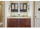 Bathroom with dual sinks, dark cabinetry, and a shower-tub combination at 5770 Dorsett Shoals Rd, Douglasville, GA 30135