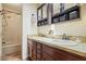 Traditional bathroom with dual vanity, dark wood cabinets, and combination shower/tub at 5770 Dorsett Shoals Rd, Douglasville, GA 30135