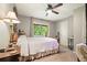 Bedroom with ceiling fan, neutral carpet, and backyard views at 5770 Dorsett Shoals Rd, Douglasville, GA 30135