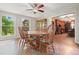 Dining room features six-chair wooden table and views of the backyard at 5770 Dorsett Shoals Rd, Douglasville, GA 30135
