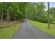Long driveway leading to a secluded property surrounded by lush greenery at 5770 Dorsett Shoals Rd, Douglasville, GA 30135