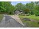 Charming home with a two-car garage, a porch, and landscaped yard with a firepit at 5770 Dorsett Shoals Rd, Douglasville, GA 30135