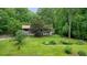 Exterior of the property showing manicured lawn, mature trees, and inviting curb appeal at 5770 Dorsett Shoals Rd, Douglasville, GA 30135