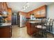 Spacious kitchen with stainless steel appliances, wooden cabinets, and breakfast bar seating at 5770 Dorsett Shoals Rd, Douglasville, GA 30135
