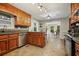 Open kitchen area with stainless steel appliances, wood cabinets, and adjacent dining area at 5770 Dorsett Shoals Rd, Douglasville, GA 30135