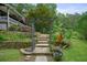 Landscaped front yard with a stone pathway, vibrant plants, and a charming garden at 5770 Dorsett Shoals Rd, Douglasville, GA 30135
