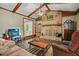 Cozy living room with a beautiful stone fireplace and hardwood flooring at 5770 Dorsett Shoals Rd, Douglasville, GA 30135