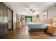 Spacious main bedroom with wood floors, a ceiling fan, and ample natural light at 5770 Dorsett Shoals Rd, Douglasville, GA 30135