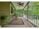 Inviting covered porch with ceiling fan and lush green views for relaxing at 5770 Dorsett Shoals Rd, Douglasville, GA 30135