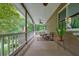 Inviting porch with seating area overlooking a lush backyard at 5770 Dorsett Shoals Rd, Douglasville, GA 30135