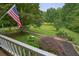 View from the porch, showcasing the lush backyard, brick pathway, and garden at 5770 Dorsett Shoals Rd, Douglasville, GA 30135