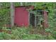 Dilapidated shed amongst natural foliage at 5770 Dorsett Shoals Rd, Douglasville, GA 30135