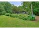 Spacious yard with lush greenery, mature trees, and picturesque landscaping at 5770 Dorsett Shoals Rd, Douglasville, GA 30135