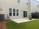 Spacious backyard boasts a concrete patio, ideal for grilling and relaxing outdoors at 209 Ellis Ln, Woodstock, GA 30189