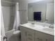 Well-lit bathroom featuring a double sink vanity and shower-tub combination at 209 Ellis Ln, Woodstock, GA 30189