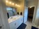 A bright bathroom featuring a dual sink vanity and a glass shower at 209 Ellis Ln, Woodstock, GA 30189