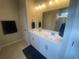 Bright bathroom featuring a dual sink vanity, modern lighting, and glass shower at 209 Ellis Ln, Woodstock, GA 30189