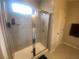 Bathroom featuring a glass shower, white door and gray walls at 209 Ellis Ln, Woodstock, GA 30189