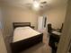 Comfortable bedroom with a ceiling fan, desk, and access to ensuite bathroom at 209 Ellis Ln, Woodstock, GA 30189