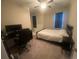 Bedroom featuring a ceiling fan, dark window shades, and desk with computer at 209 Ellis Ln, Woodstock, GA 30189