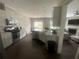 Spacious kitchen with stainless appliances, white cabinets, and opens into the living room at 209 Ellis Ln, Woodstock, GA 30189