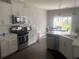 Bright kitchen features white cabinets, stainless steel appliances, and a breakfast nook at 209 Ellis Ln, Woodstock, GA 30189