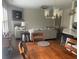 Inviting living room with a fireplace and ample seating, seamlessly connects to the dining area at 209 Ellis Ln, Woodstock, GA 30189