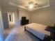 A main bedroom with a ceiling fan and neutral carpet at 209 Ellis Ln, Woodstock, GA 30189