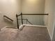 Carpeted staircase with dark wood banister at 209 Ellis Ln, Woodstock, GA 30189