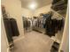 A large walk-in closet with shelving for shoes, clothes and accessories at 209 Ellis Ln, Woodstock, GA 30189