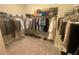 A spacious walk-in closet with shelving and rods for organized storage at 209 Ellis Ln, Woodstock, GA 30189