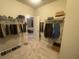 A large closet with clothes, shoes and accessories on display at 209 Ellis Ln, Woodstock, GA 30189